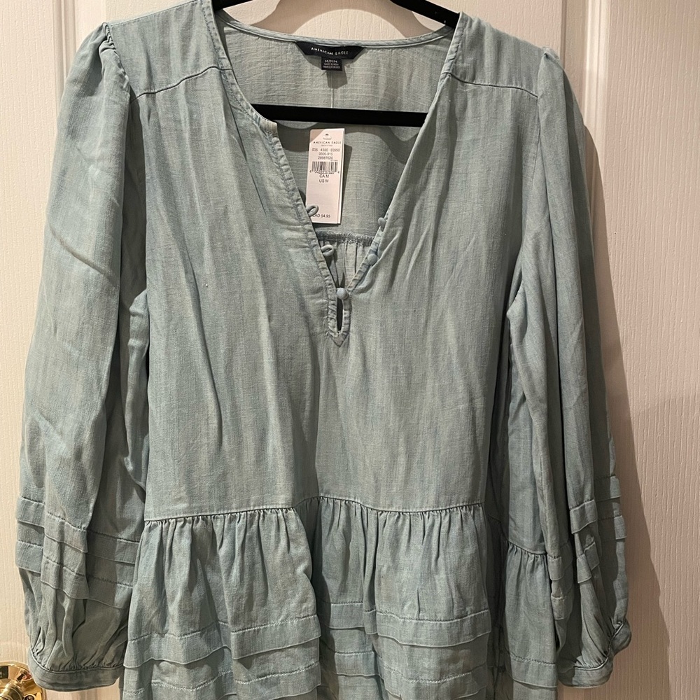 American Eagle light denim top with button detailing. Brand new.